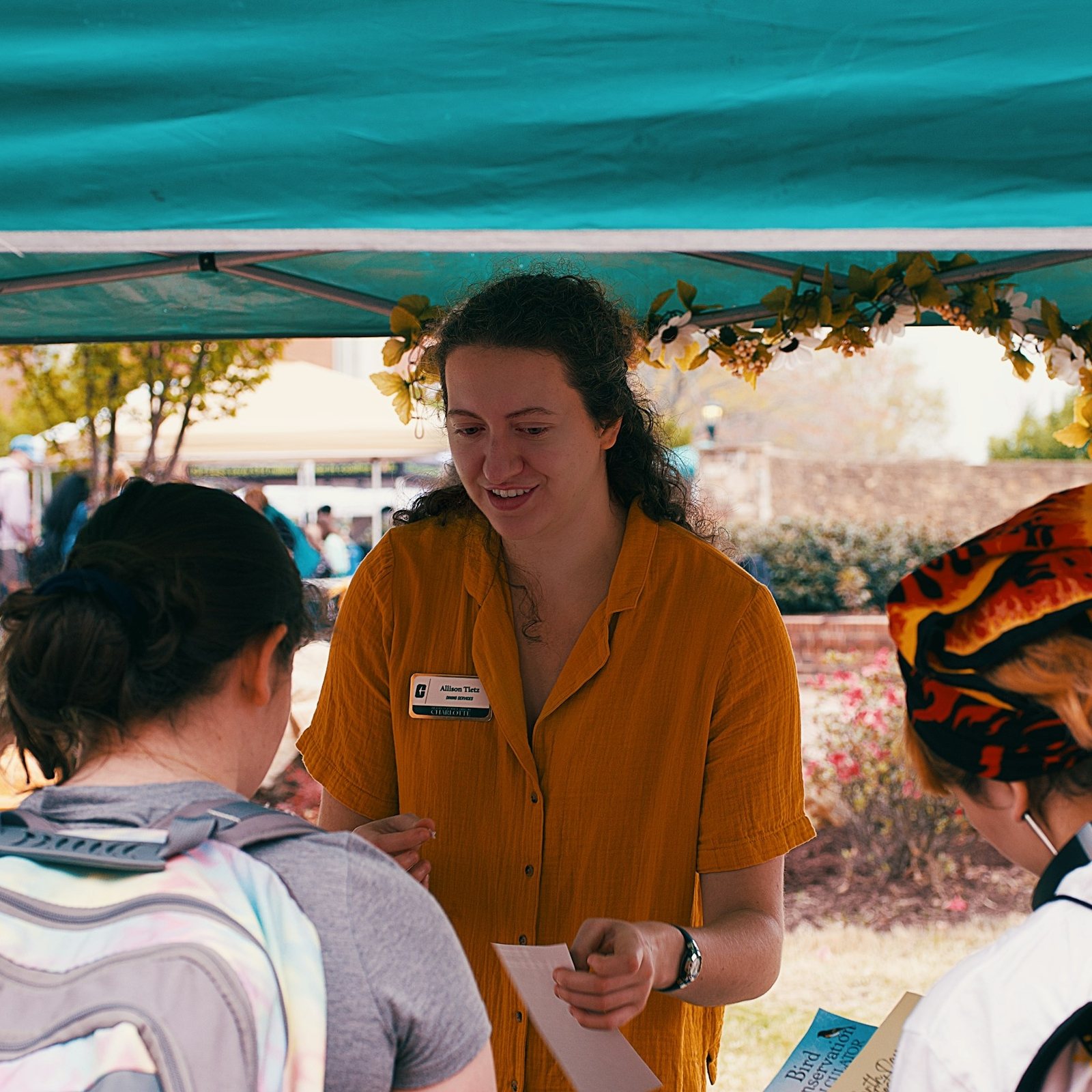 A volunteer meeting people at a community outreach table