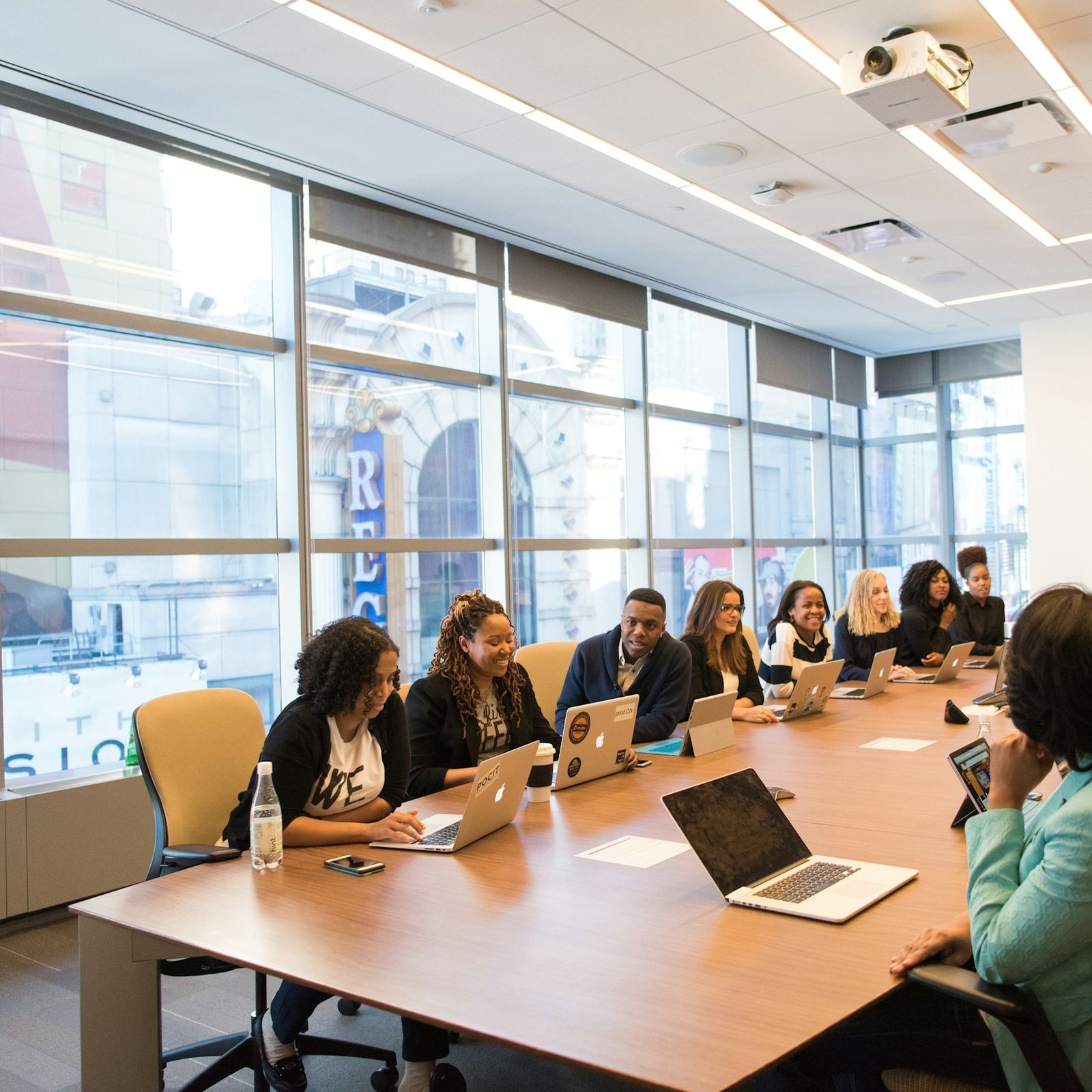 A group seated around a long conference table during a working meeting