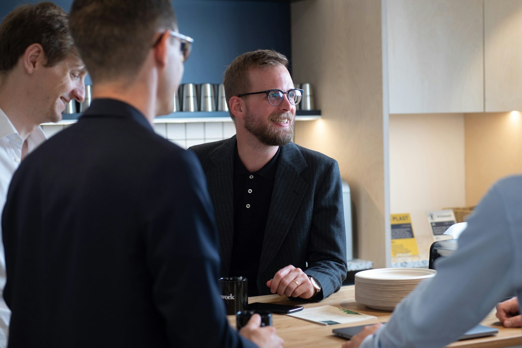 Two people talking across a counter during an appointment
